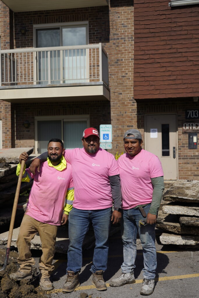 three construction workers wearing pink for breast cancer awareness