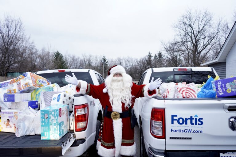 Santa at fortis paving fill my truck charity event trucks filled with donations.
